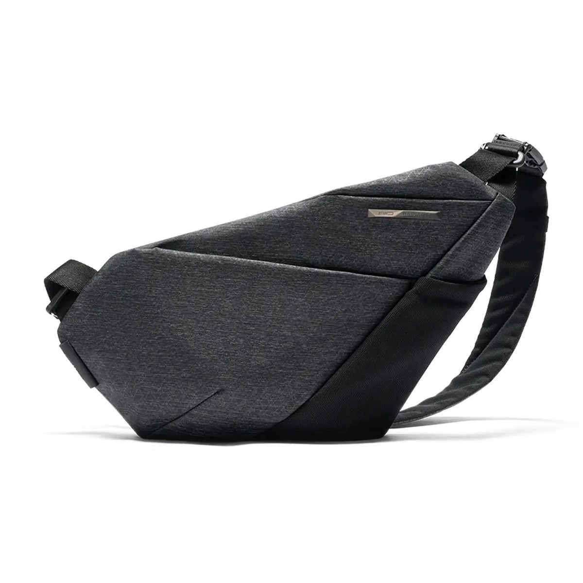 Side angle studio shot of Gray Shadow Grid FINO V Ultra-slim Tech Sling crossbody bag, right-handed geometric woven nylon chest fanny pack, engraved metal brand plate, adjustable wide shoulder strap, lightweight waterproof anti-theft minimalist tech bag shot on solid white background