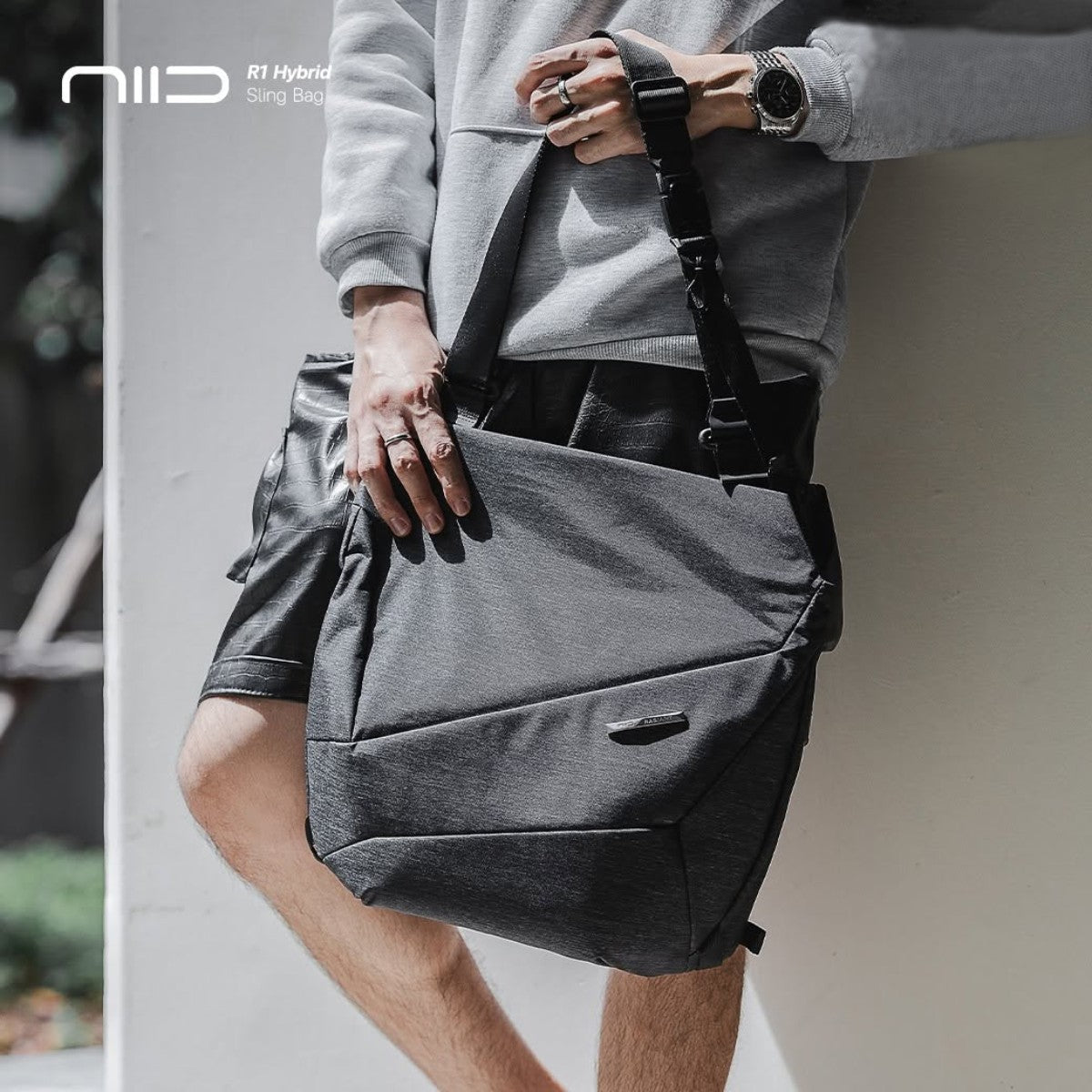 Men wearing NIID R1 Hybrid Sling Bag grey heathered fabric convertible crossbody shoulder bag for daily commute casual outdoor use