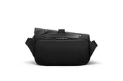 Back view of meteorite black NIID R1 Radiant Urban Sling crossbody bag, waterproof unisex nylon anti-theft chest pack with rear zipper pocket, top carry handle and adjustable shoulder straps, studio shot on plain white background for travel and daily carry