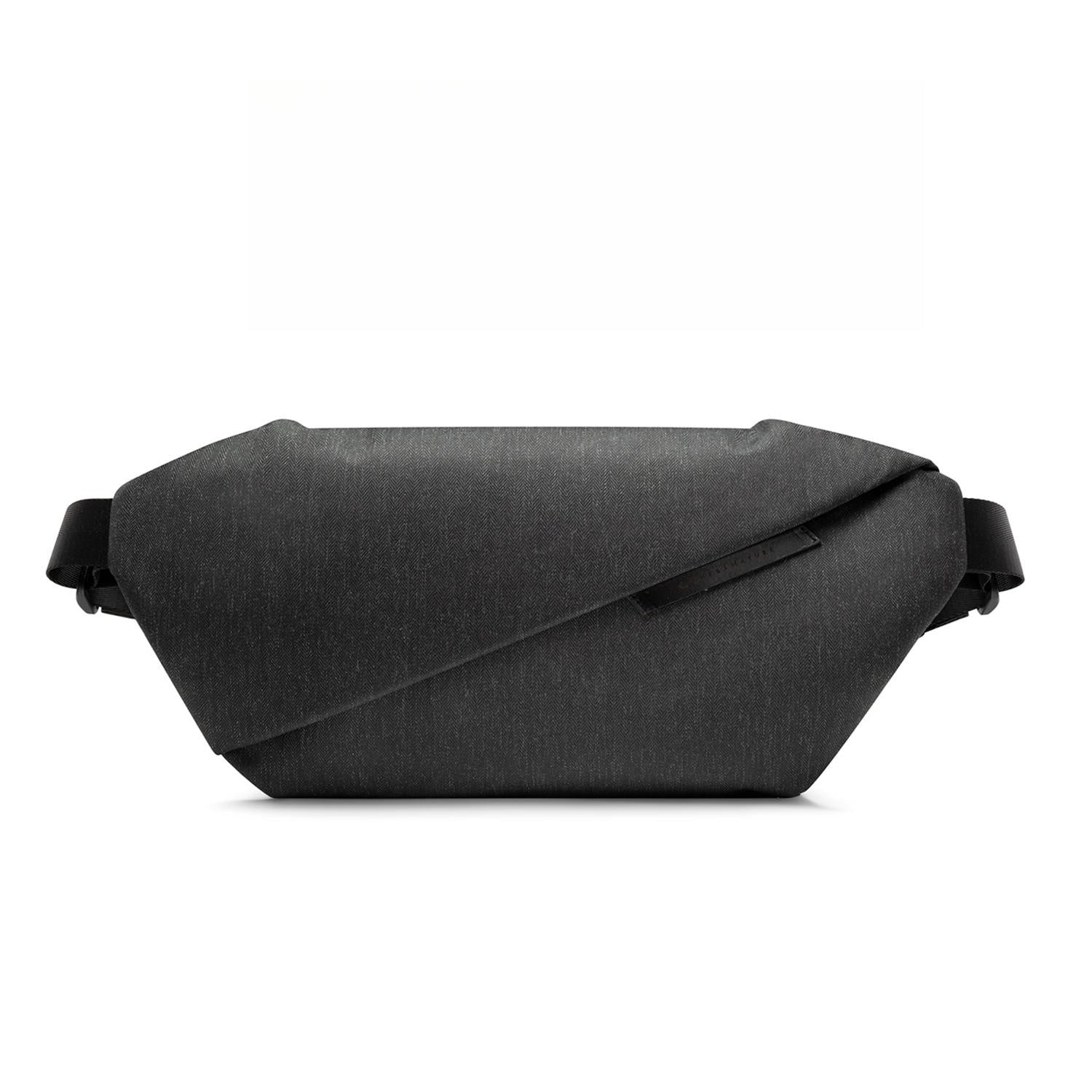Front studio shot of Meteorite Black NIID RO Plus Sling Bag, minimalist waterproof woven nylon crossbody chest fanny pack with diagonal fold design, adjustable full shoulder straps, clean 1:1 square white e-commerce product background for variant gallery