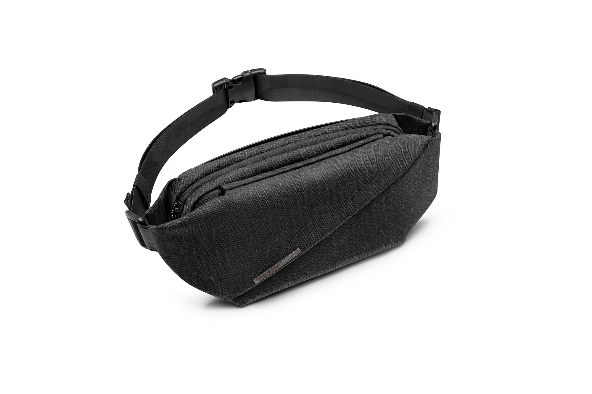 Angled front shot of Indigo NIID RO Radiant Chest Bag, herringbone textured waterproof nylon crossbody chest pack, multi-layer zipper compartments, quick-release buckle shoulder strap and engraved metal brand tag