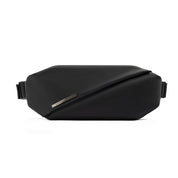 Front flat studio shot of Meteorite Black NIID RO Radiant Chest Bag, anti-theft waterproof nylon crossbody chest fanny pack with diagonal fold cover and engraved metal brand plate, adjustable side shoulder straps