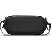 Back flat bottom view of black NIID S6 Hybrid Sling crossbody bag, full plain rear panel without logo, adjustable black shoulder straps with yellow plastic pull tab, minimalist white studio background