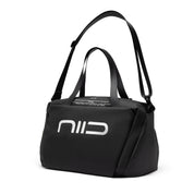 Three-quarter view black NIID S6 Hybrid Sling duffle crossbody bag, equipped with short hand handles and full adjustable long shoulder strap, large silver NIID logo on front, plain white studio background