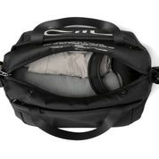 Top-down overhead shot of open black NIID S6 Hybrid Sling crossbody bag, visible inner compartment with padded divider, fabric lining with printed text, dual top handles, plain white studio background