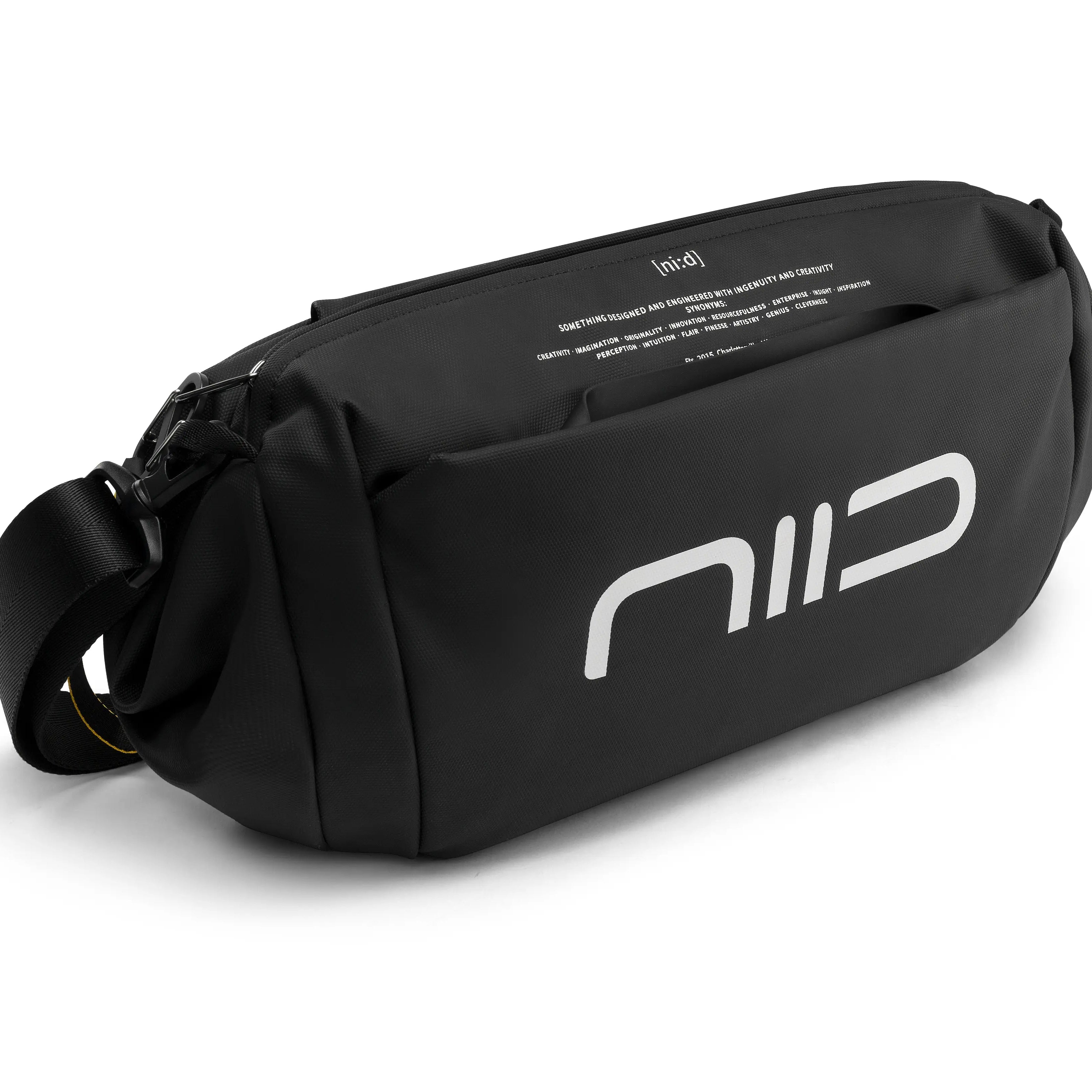 Side detail shot of black NIID S6 Hybrid Sling crossbody fanny pack with large white front NIID logo, external front pocket, printed inner lining text and adjustable woven shoulder strap, white studio background