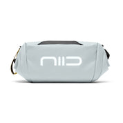 Side close-up shot of gray NIID S6 Hybrid Sling crossbody bag with large white front logo, black top handle and yellow branded zipper tag, minimalist compact sling bag on plain white background