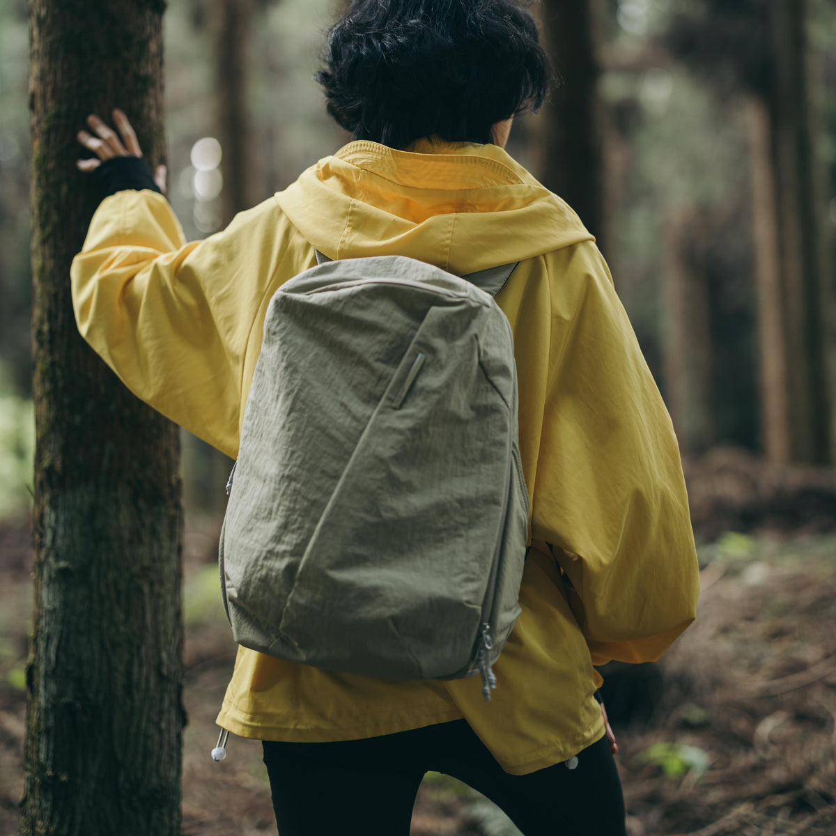 NIID NEO Nomad 19L Backpack in Sage Green - Model Back View in Forest