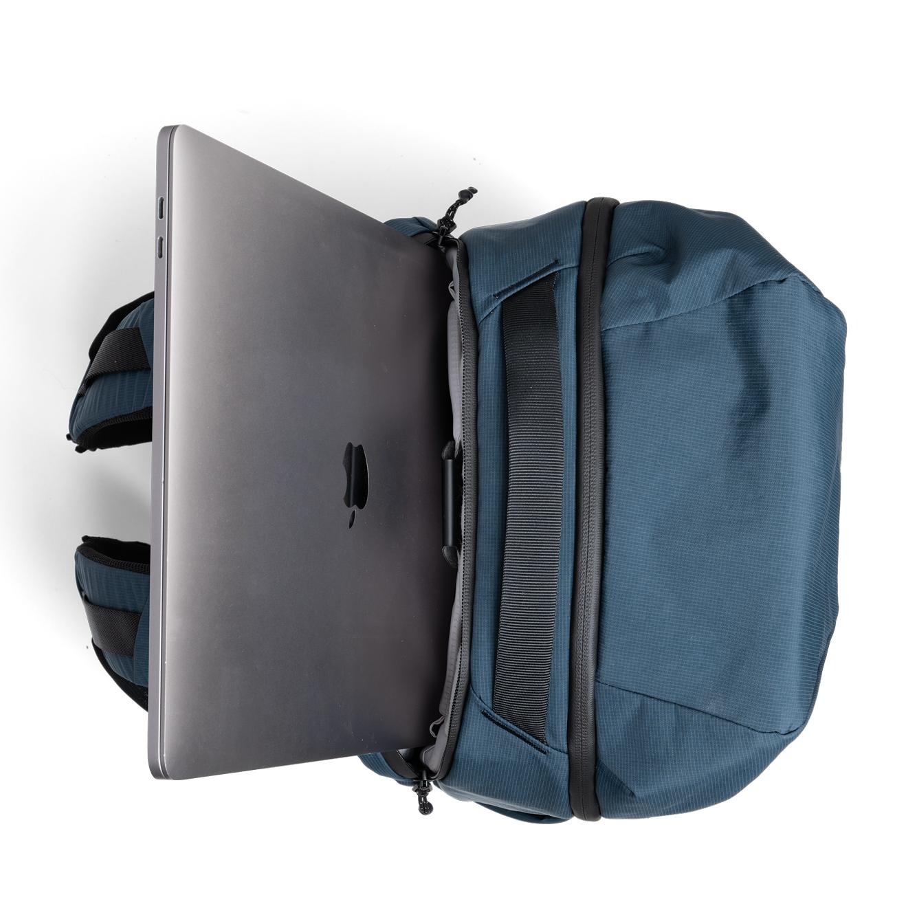 NIID NEO Nomad Backpack N4 in Prussian Blue open showing padded laptop sleeve with MacBook inside.