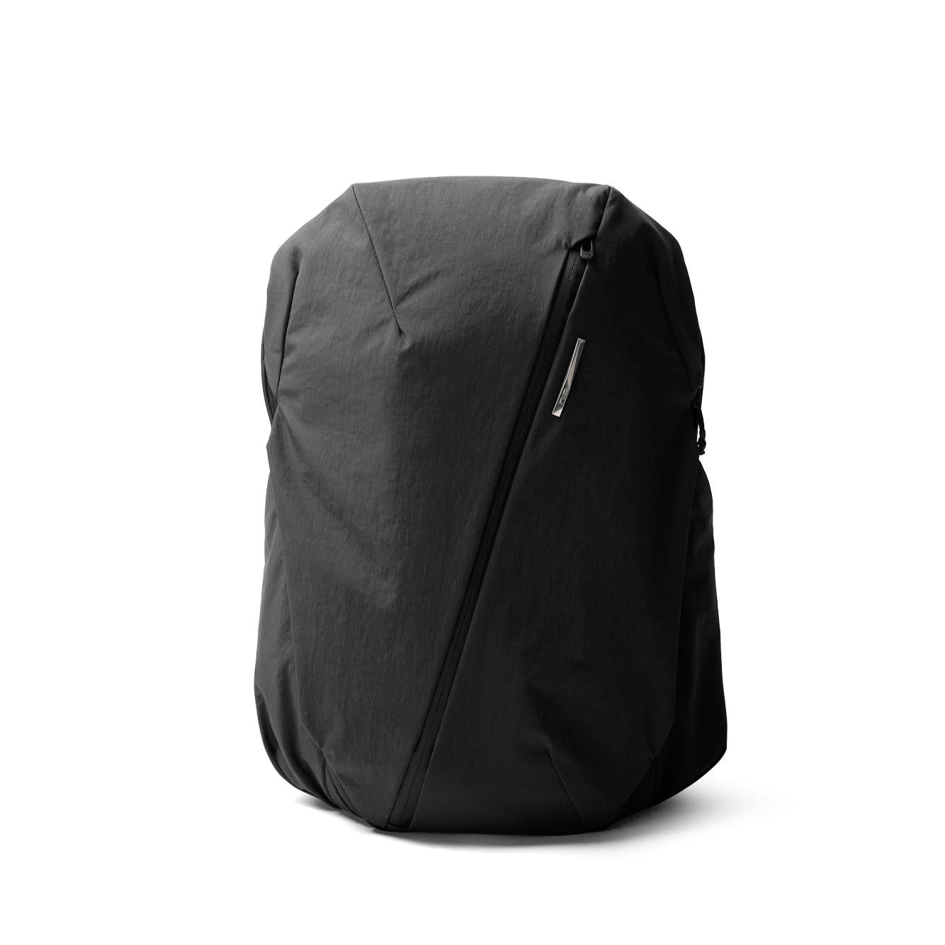 NIID NEO Nomad 30-32L Backpack N4 in Roman Black, front view closed product shot showing angular design and diagonal zipper, white background.