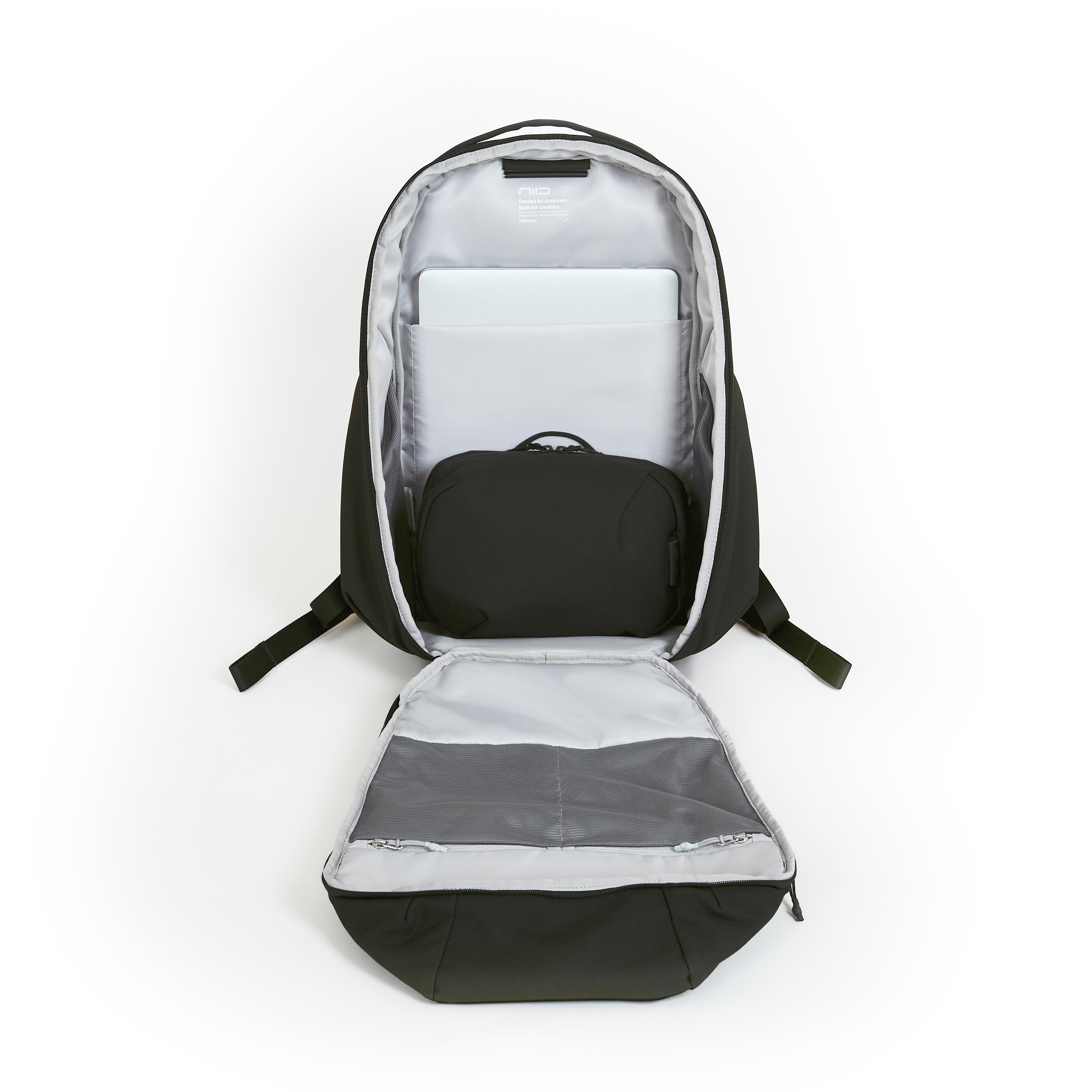 NIID NEO Nomad 30-32L Backpack N4 in Roman Black open showing padded laptop sleeve and black organizer pouch in main compartment.
