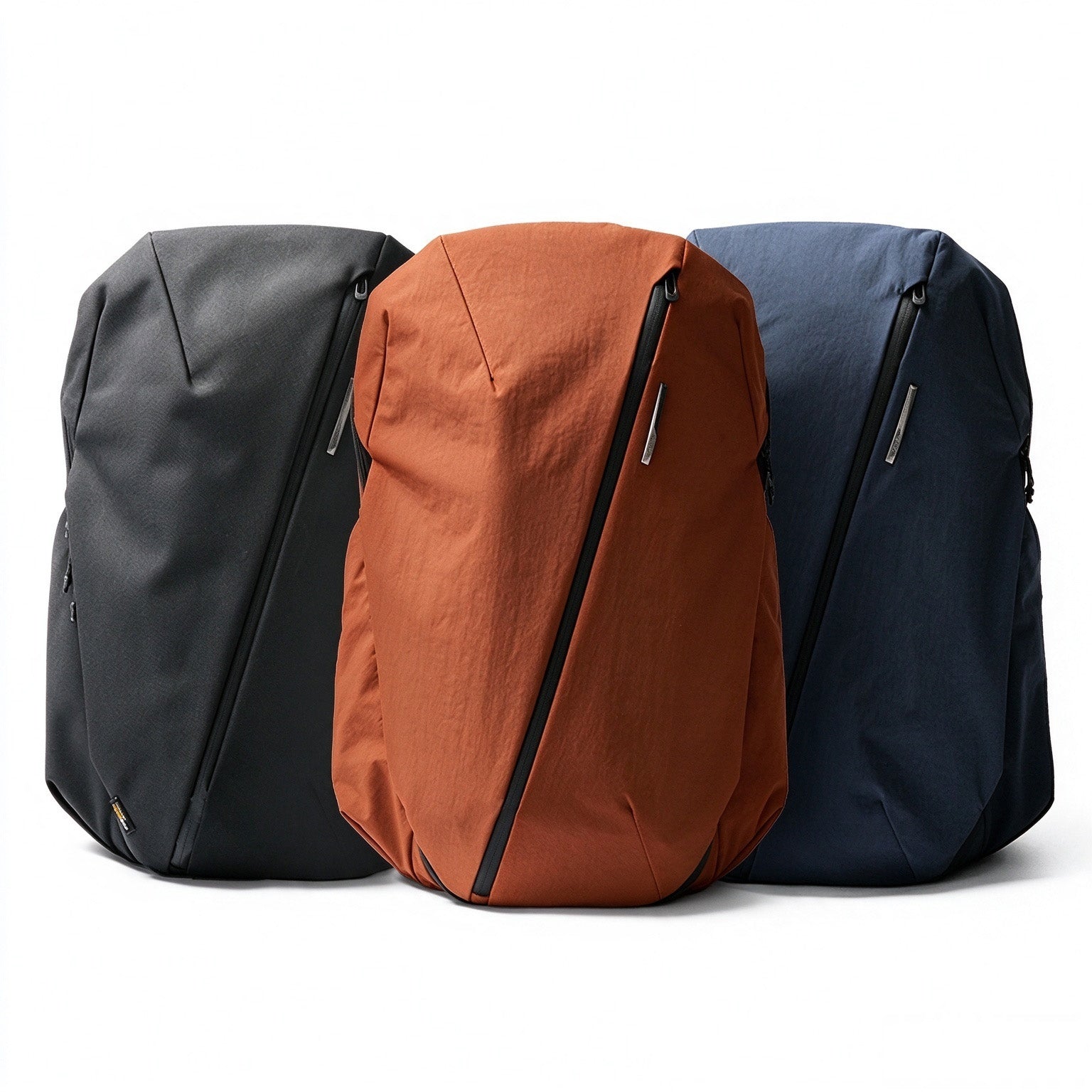 NIID NEO Nomad 30-32L Backpack N4 in three colorways: Roman Black, Venetian Red and Prussian Blue, white background product lineup.