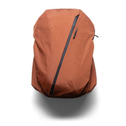 NIID NEO Nomad Backpack N4 in Venetian Red, front view closed product shot showing diagonal zipper and NIID logo plate.