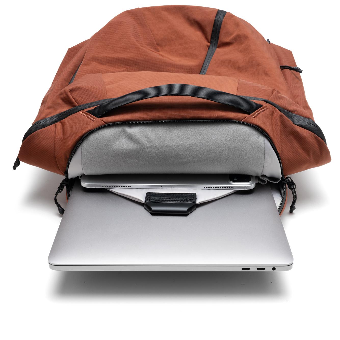 NIID NEO Nomad Backpack N4 in Venetian Red open showing padded laptop sleeve with laptop and tablet inside.