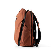 NIID NEO Nomad Backpack N4 in Venetian Red, three-quarter side view showing shoulder straps and side profile.