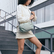 NIID NEO Nomad 4L Sling Bag‑N1 Mint Green unisex waterproof lightweight crossbody sling bag, female model urban stair outdoor scene, 4L everyday EDC chest bag