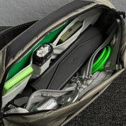 Close‑up interior shot of open NIID NEO Nomad 5L Sling Bag‑N1L pearly gray, neatly organized compartments packed with cables, power bank, earbuds and daily EDC gear, show multi‑pocket storage design.