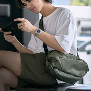 Man wearing NIID N1L dewy moss green sling crossbody bag, casual street style daily carry photo