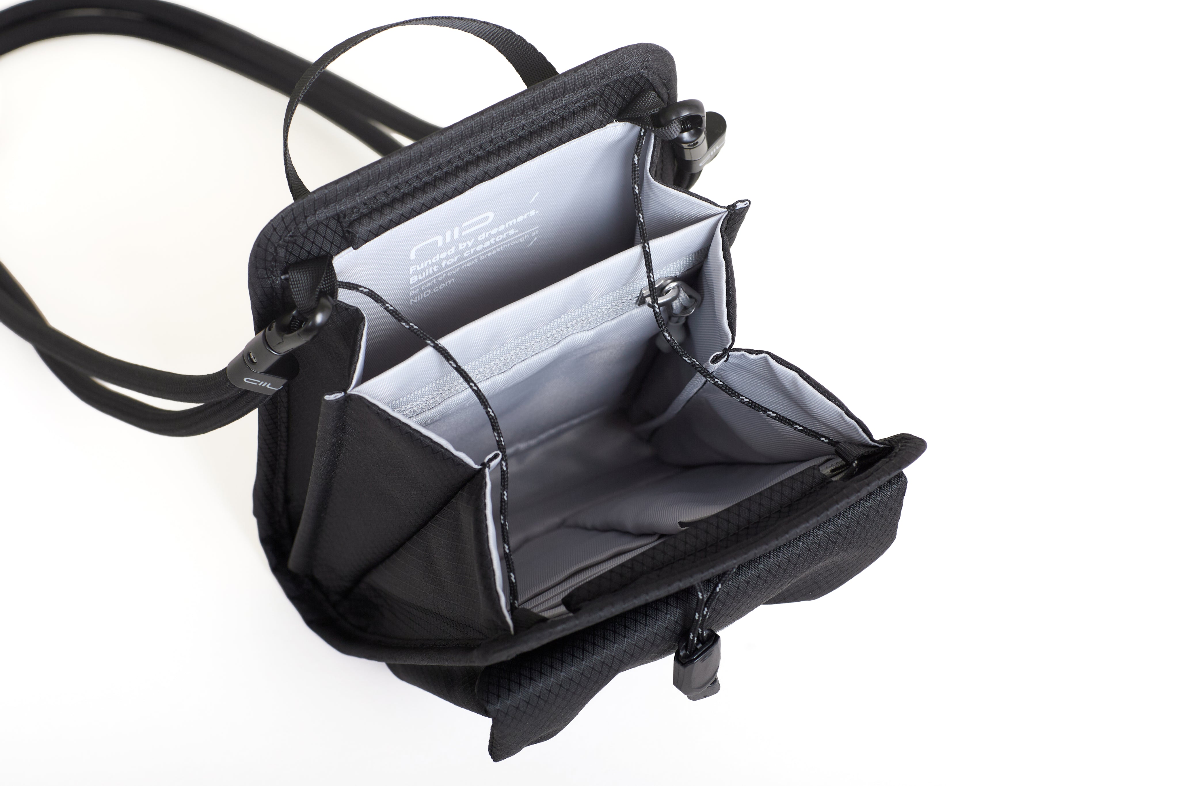 NIID NEO Nomad Pouch in Diamond Grid Black open showing NIID branded lining, zippered mesh pocket and card slots.