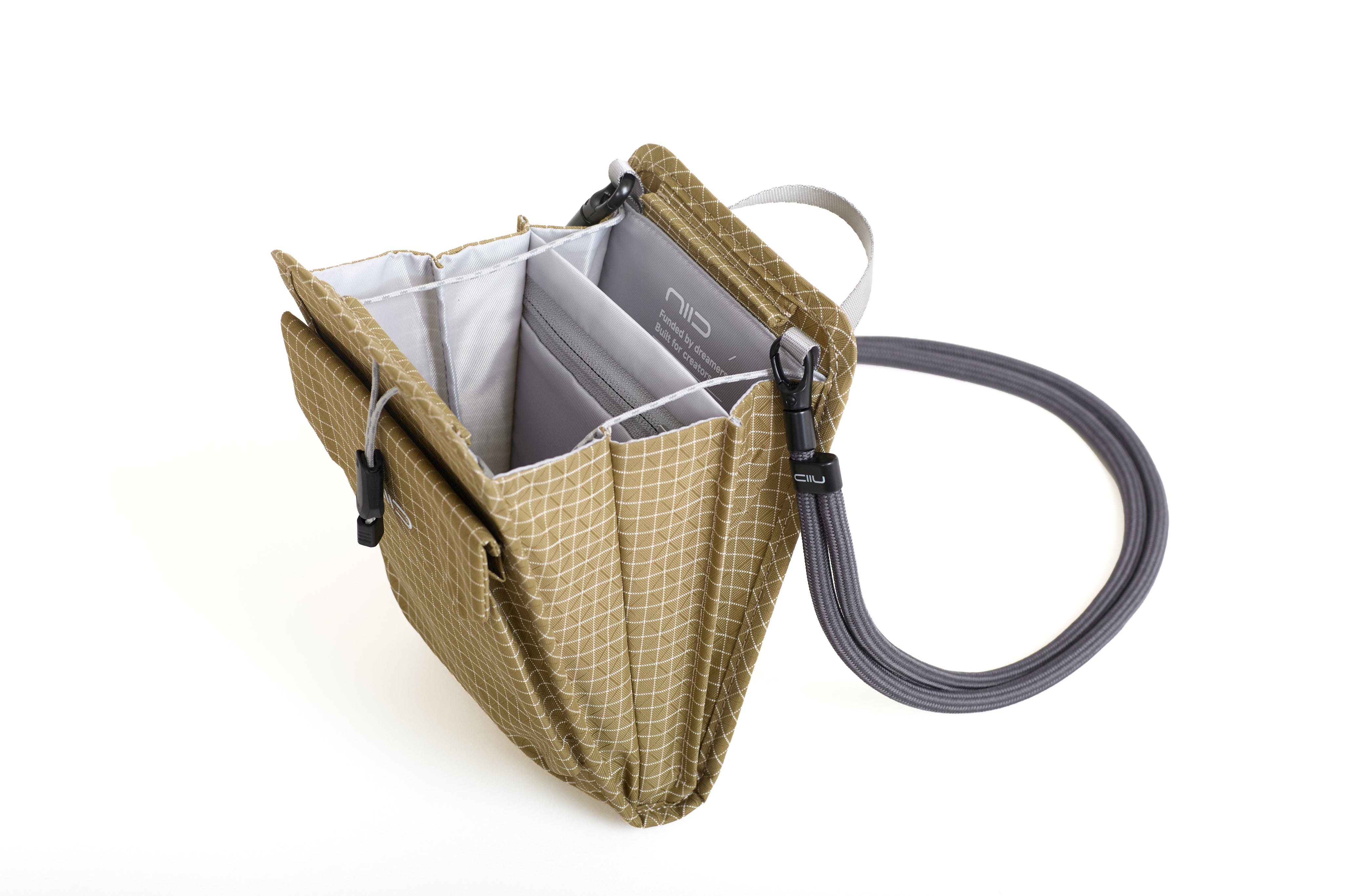 NIID NEO Nomad Pouch in Dune Tan Ripstop open showing gray interior compartments and attached braided lanyard strap with NIID clip.