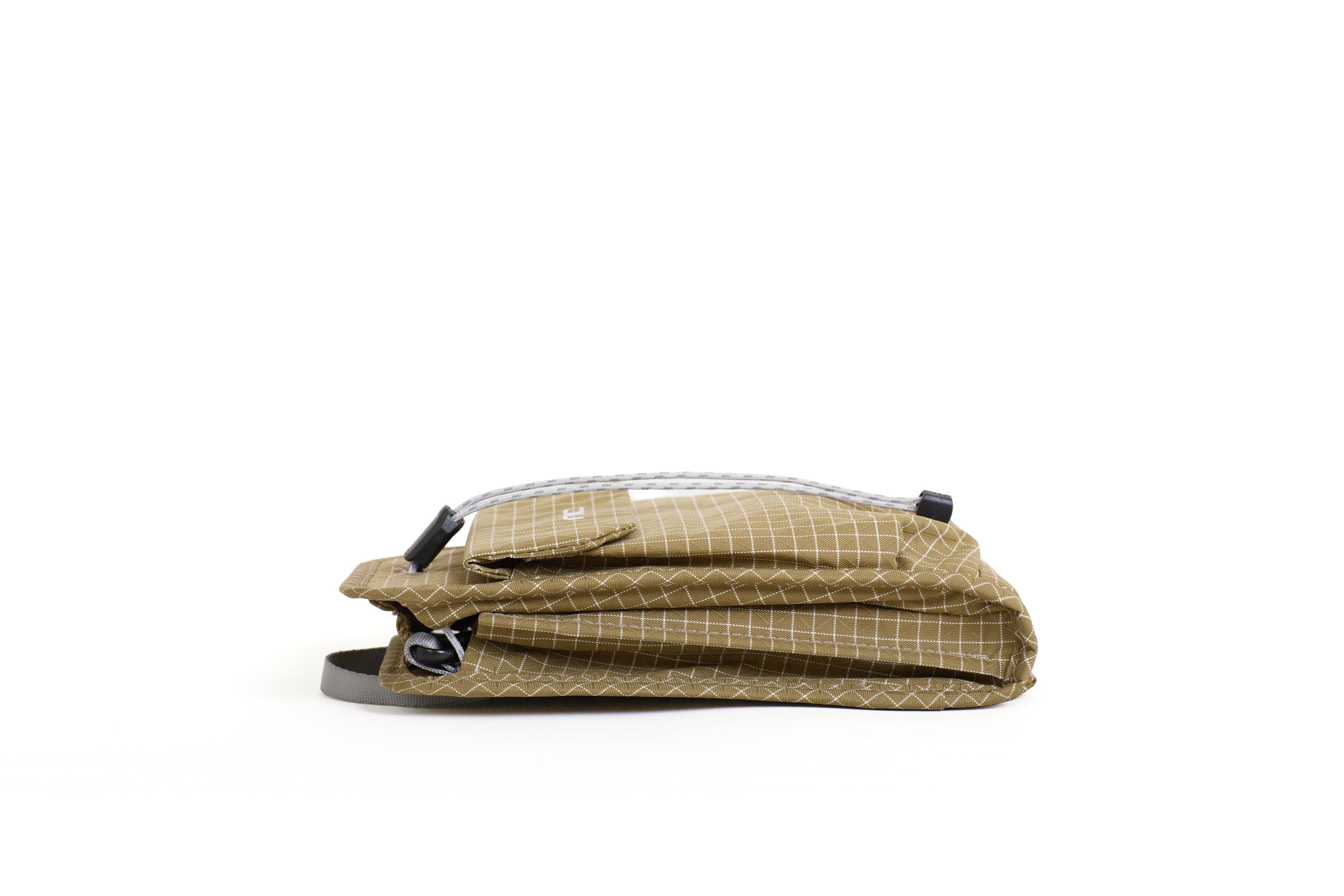NIID NEO Nomad Pouch in Dune Tan Ripstop, side view showing bottom strap loop and drawstring closure detail.
