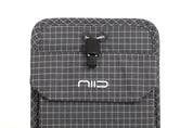 Close-up of Graphene Gray Nomad Pouch front flap showing NIID logo, black drawstring cord lock and fabric eyelets.
