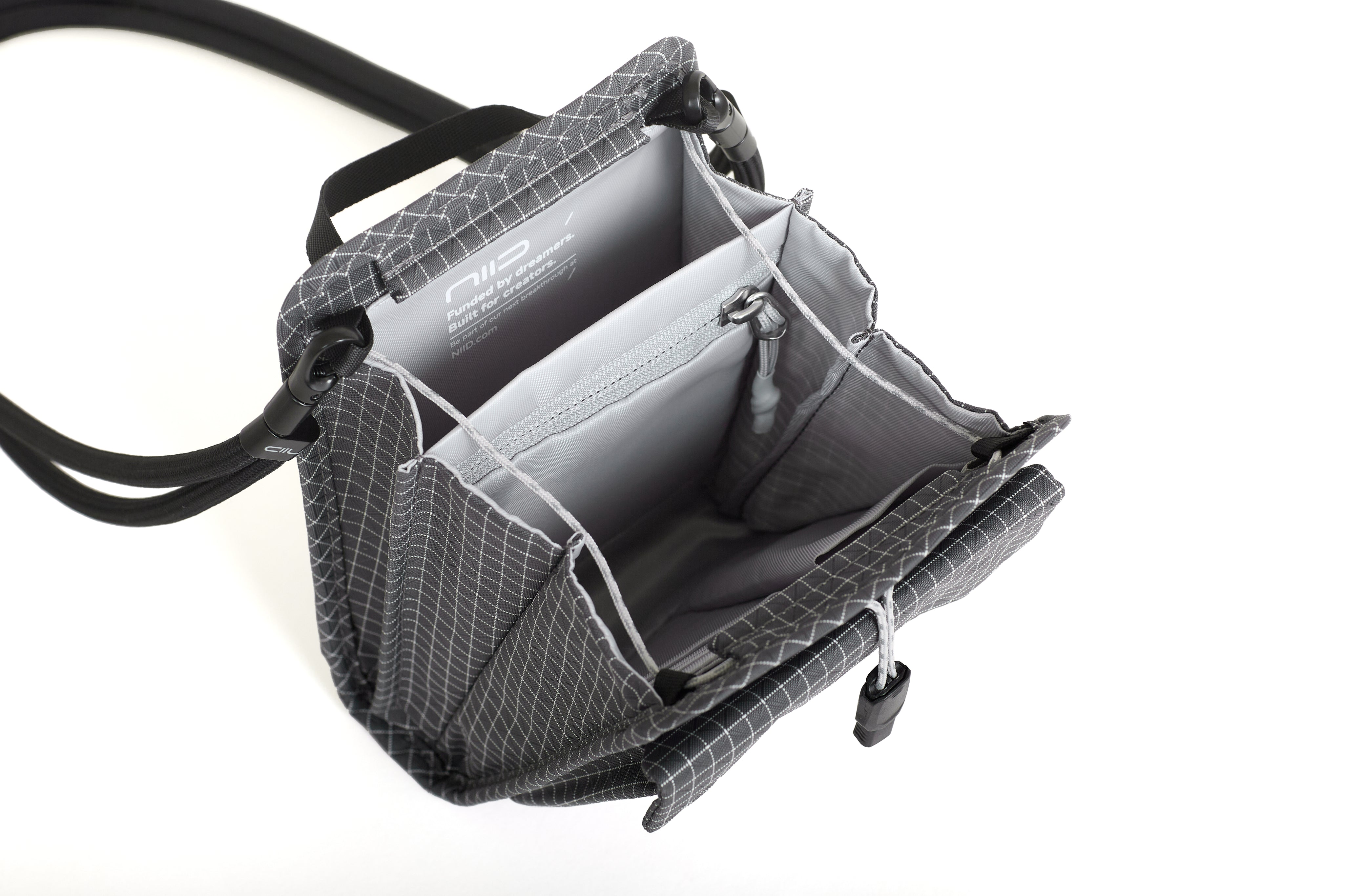 NIID NEO Nomad Pouch in Graphene Gray Ripstop open showing NIID branded lining, zippered mesh pocket and card slots.
