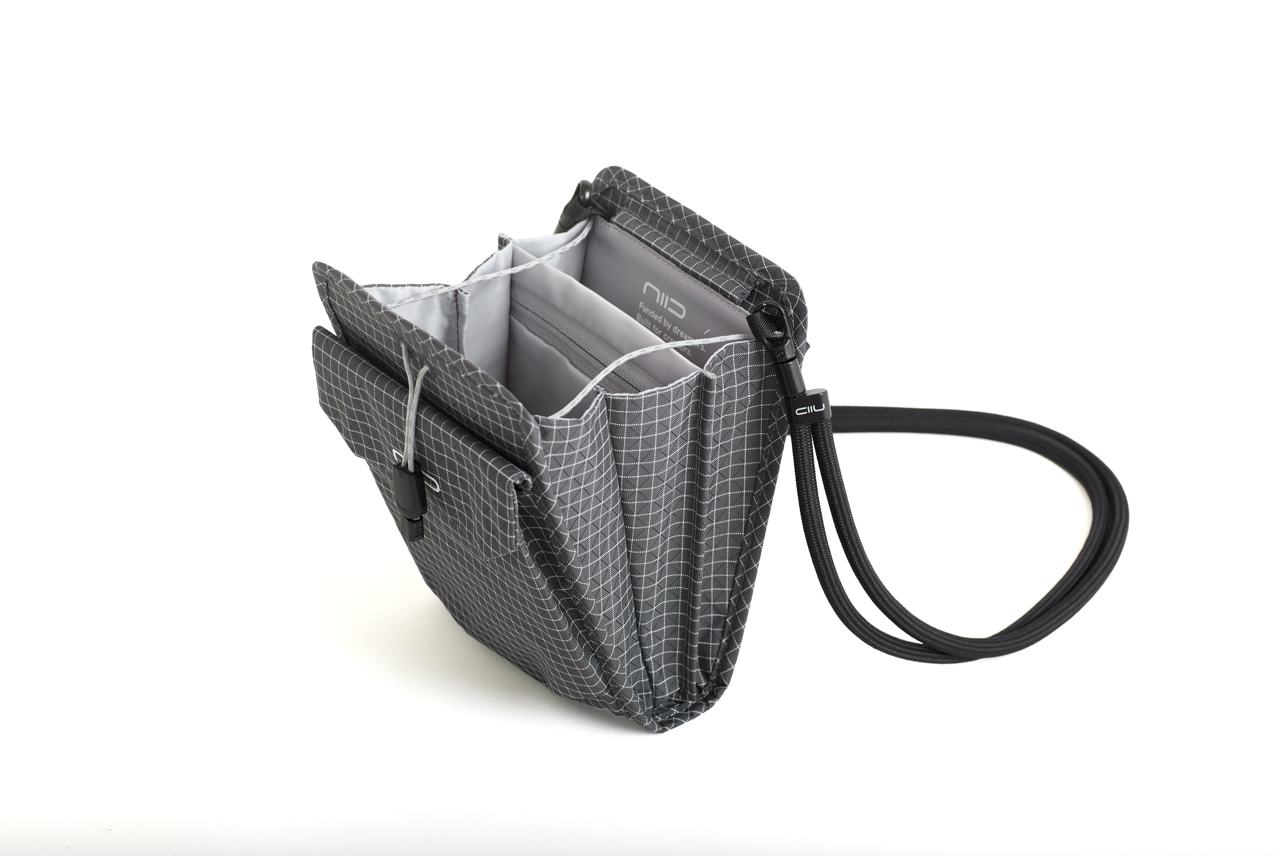 NIID NEO Nomad Pouch in Graphene Gray Ripstop open showing gray interior compartments and attached black braided lanyard strap with NIID clip.