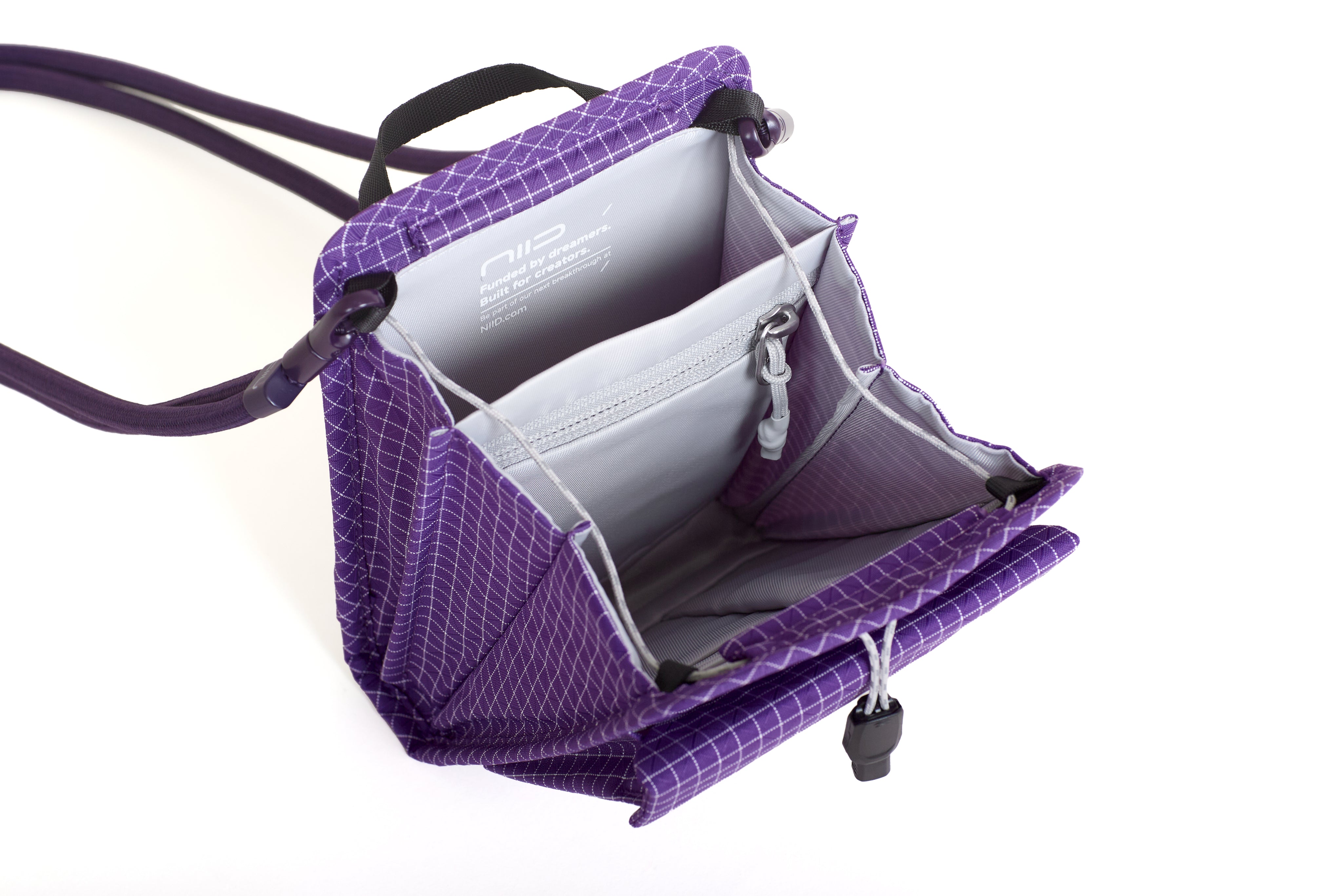 NIID NEO Nomad Pouch in Nebula Purple Ripstop open showing NIID branded lining, zippered mesh pocket and card slots.
