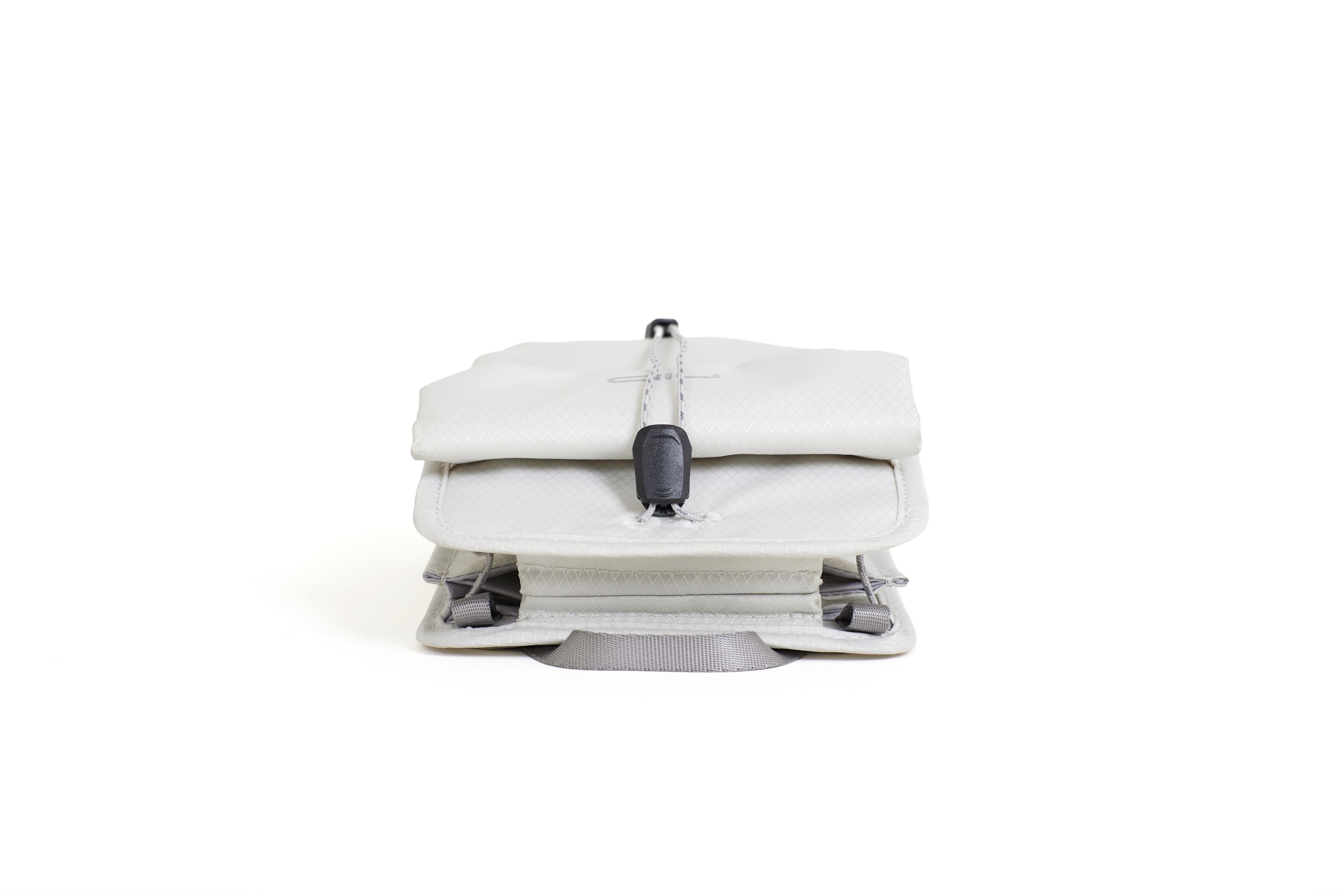 NIID NEO Nomad Pouch in Pearly White, front view standing closed showing drawstring clasp and bottom carry strap.