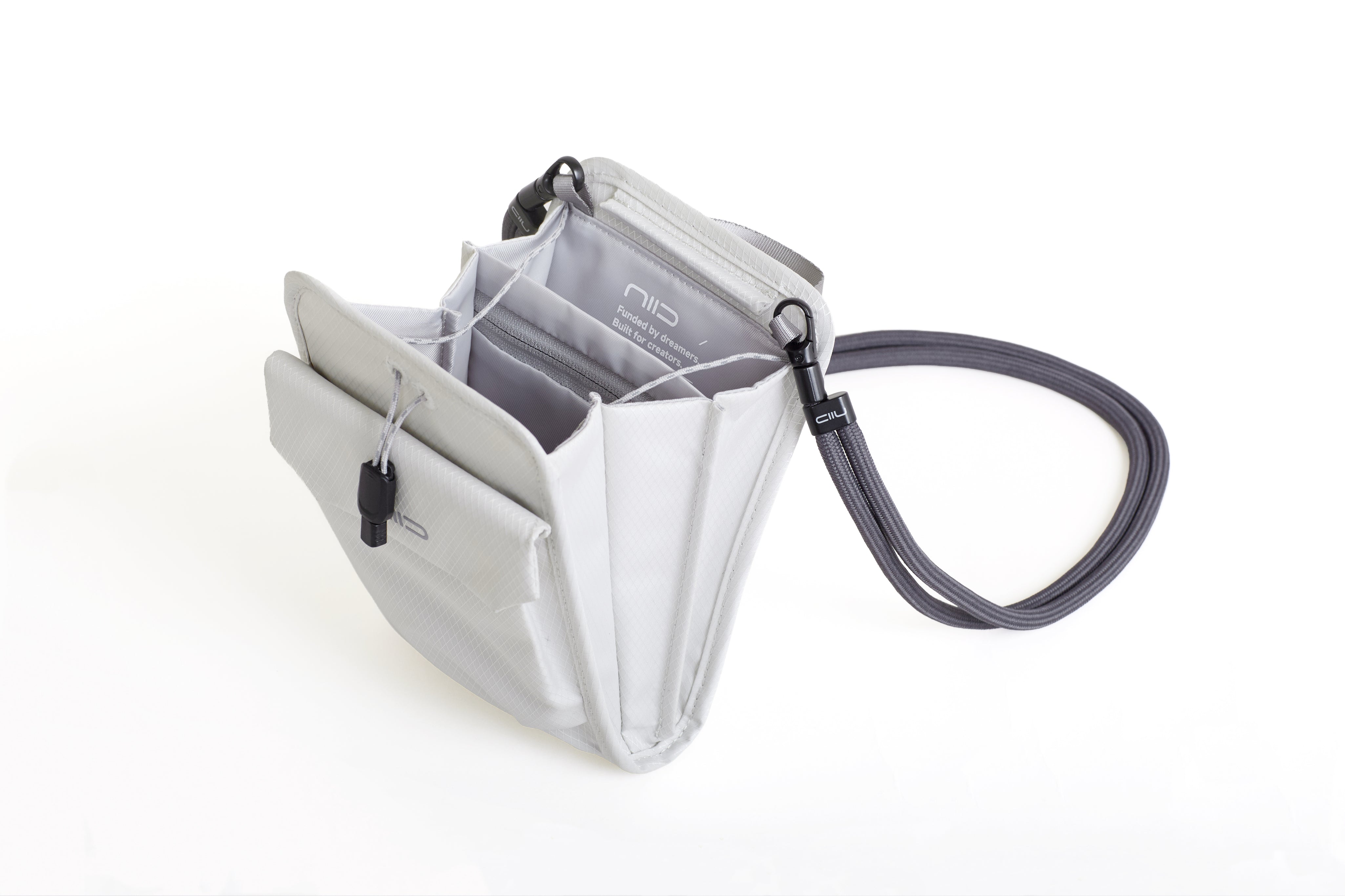 NIID NEO Nomad Pouch in Pearly White open from alternate angle showing interior organization and gray lanyard strap.