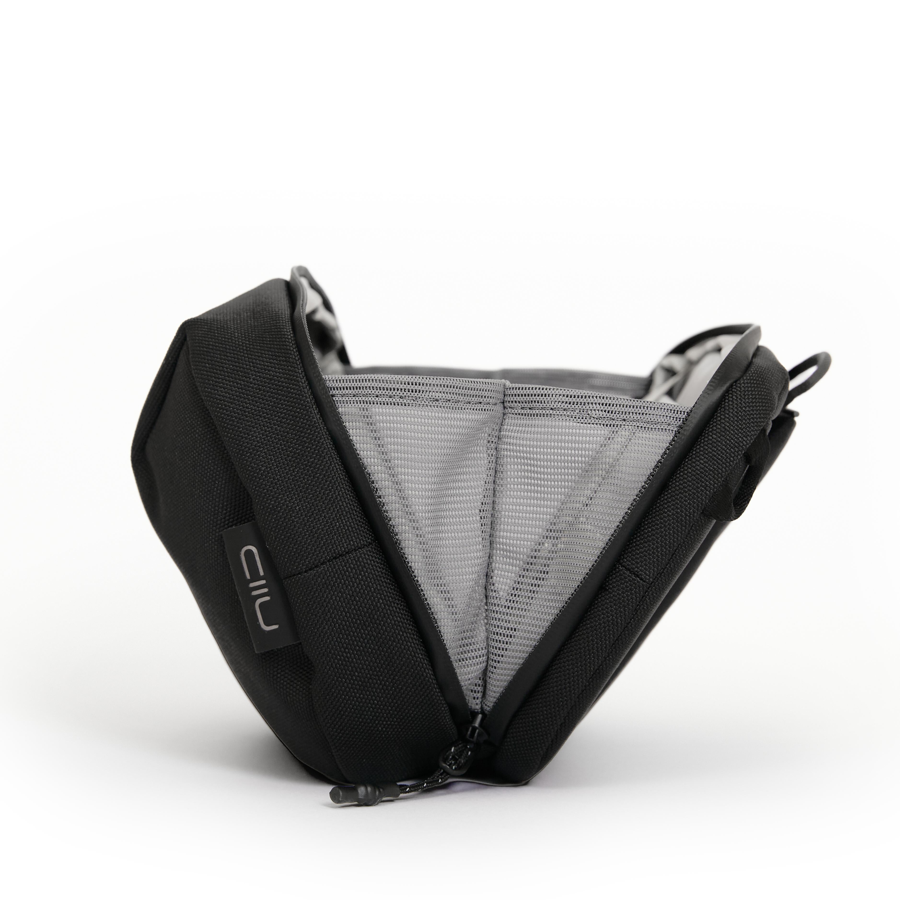 NIID NEO Tech Pouch in black side angle showing interior mesh divider pockets and elastic loops, NIID logo tag on exterior.