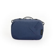NIID NEO Tech Pouch in Prussian Blue, front view closed showing top handle, zipper pulls and side D-rings.