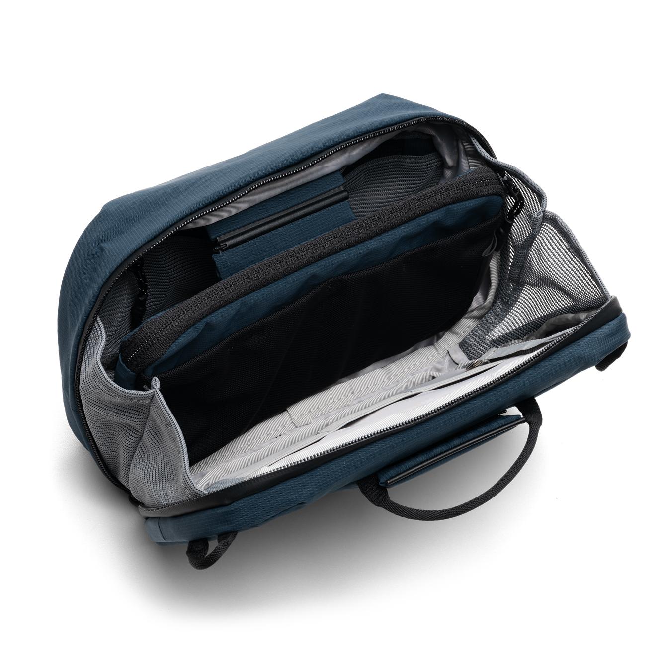 NIID NEO Tech Pouch in Prussian Blue open showing interior mesh divider pockets and elastic loops, empty organizer.