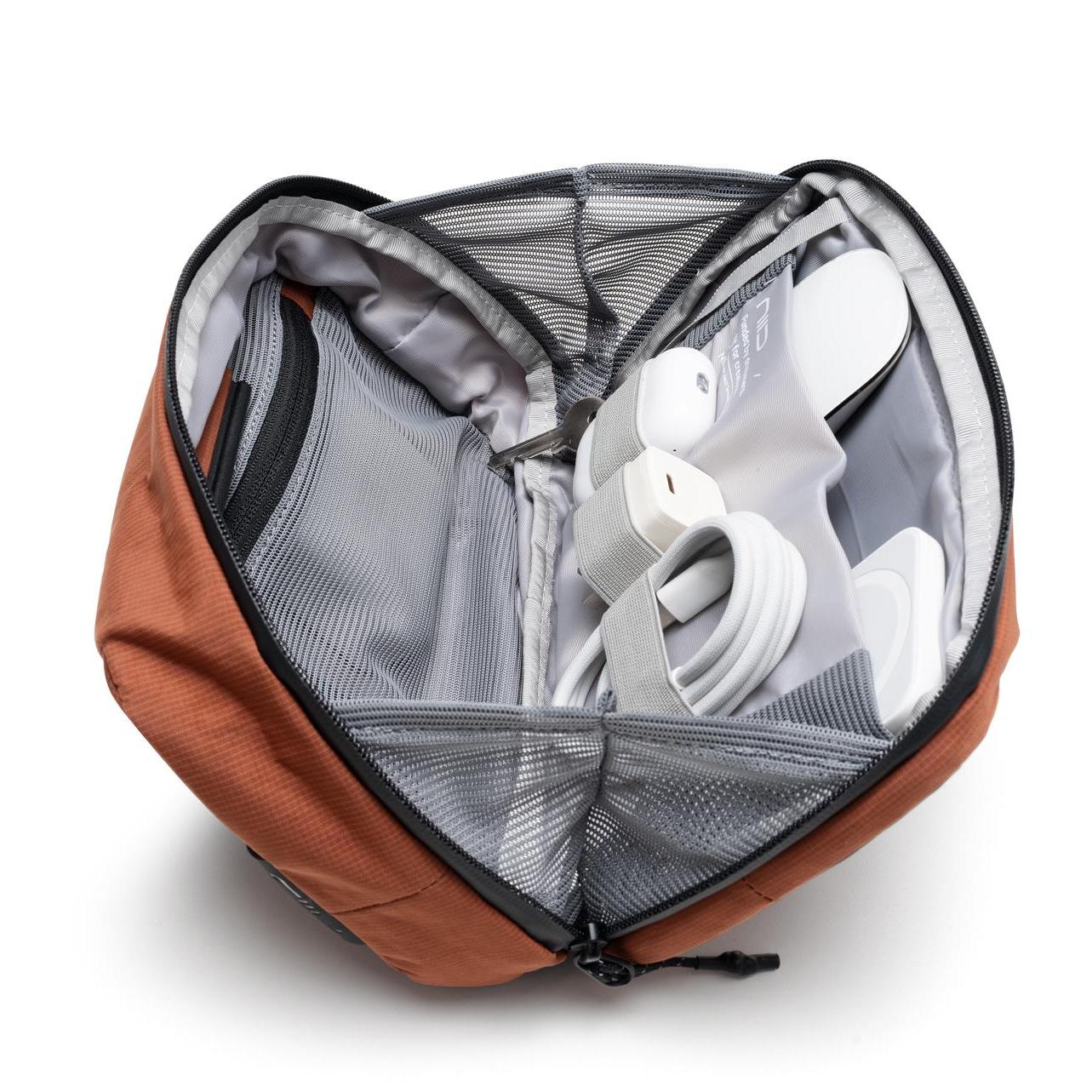 NIID NEO Tech Pouch in Venetian Red open showing mesh divider and elastic loops organizing tech accessories.