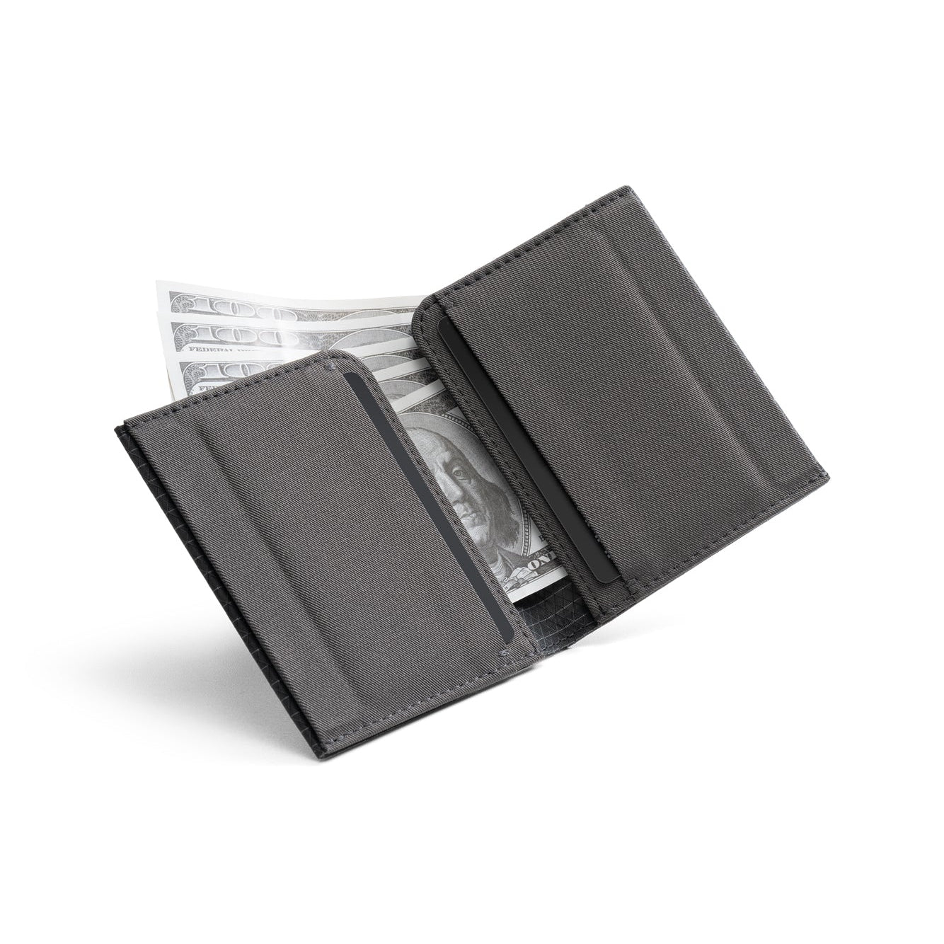 Open dark gray Nebula fabric NIID NEX slim bifold wallet on plain white background, card slots visible with US dollar bills tucked inside, inner fabric texture display of lightweight minimalist men’s EDC card holder
