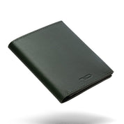 Dark green genuine leather NIID NEX slim bifold wallet floating on clean plain white background, subtle soft shadow underneath, embossed NIID logo on lower front, minimalist men's EDC card wallet product shot