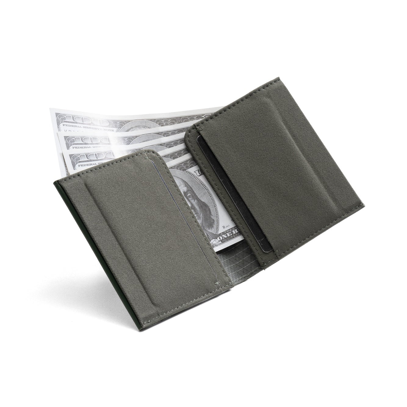 Open dark gray Nebula fabric NIID NEX slim bifold wallet on plain white background, card slots visible with US dollar bills stored inside, interior structure display of minimalist men's EDC card holder