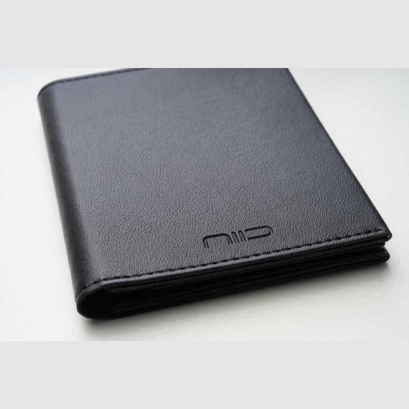 Close‑up shot of black smooth genuine leather NIID NEX Slim Wallet, embossed NIID logo, minimalist bifold men's card wallet