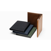 Four‑color collection of NIID NEX Slim smooth‑leather wallets (Black, Olive, Navy, Brown), one opened‑up to display inner‑layer structure, minimalist men leather card holders