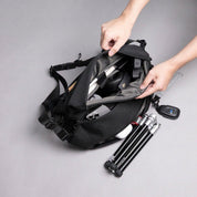 NIID R1 RADIANT MEGA in Black open showing compartments with camera, phone, headphones and tripod, everyday carry capacity shot.
