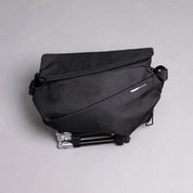 NIID R1 RADIANT MEGA in Black, closed product shot showing scratch-resistant textured fabric and NIID logo plate, gray background