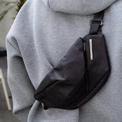 NIID Radiant R2 Everyday Sling Bag Diamond Grid Black, real‑buyer chest wearing close‑up shot, modular EDC crossbody sling bag with silver brand tag.