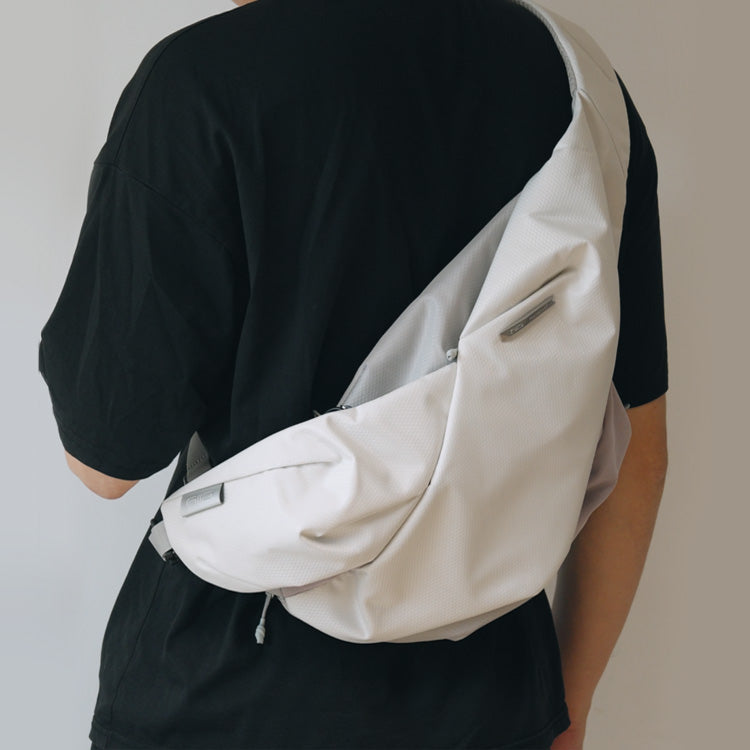 NIID Radiant R2 Everyday Sling Bag Diamond Grid Gray modular crossbody sling bag, close‑up back wearing angle, urban EDC tech sling bag