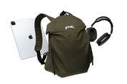 Olive green NIID VIA roll-top backpack paired with tablet and over-ear headphones, showcasing spacious storage capacity ideal for daily office commutes and digital carry