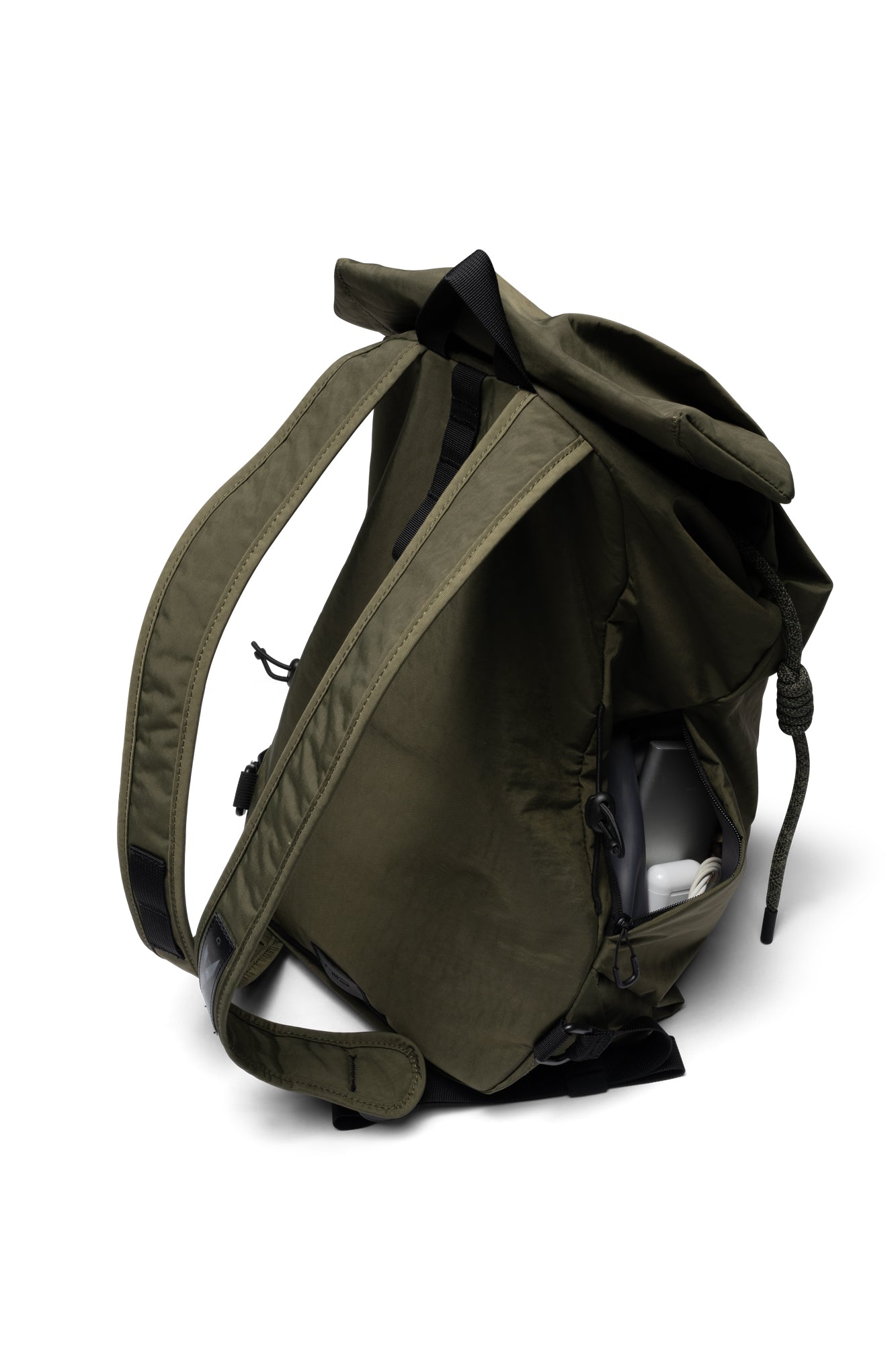 Three-quarter rear angle shot of olive green NIID VIA roll-top backpack, showcasing padded adjustable shoulder straps and handy side slip pocket for small daily accessories