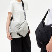 Two‑person display for NIID VIA Gym Bag of light‑grey and black colourway, minimalist white studio background