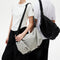 Two‑model display of NIID VIA Gym Bag in black and light‑grey on plain white studio background