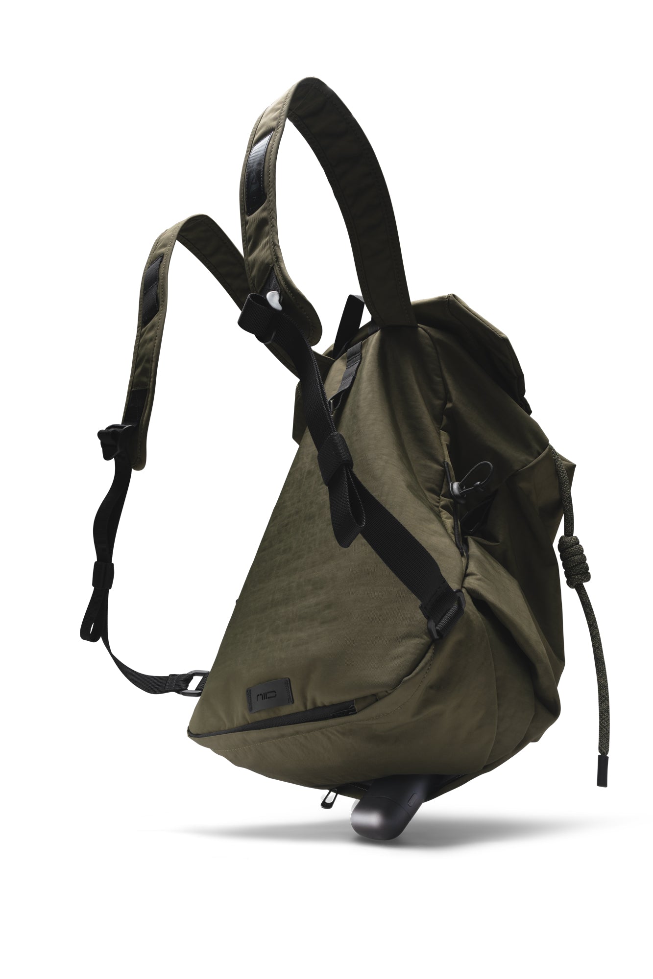 Three-quarter rear studio shot of olive green NIID VIA roll-top backpack against plain white background, equipped with adjustable padded shoulder straps, black buckle fasteners, bottom zipper pocket, brand leather label and thick braided drawstring side cord for daily commute and lightweight outdoor carry