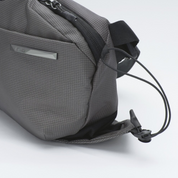 Side elastic drawstring detail of NIID N1 sling bag, expandable pocket to hold small items like keys and earphones.